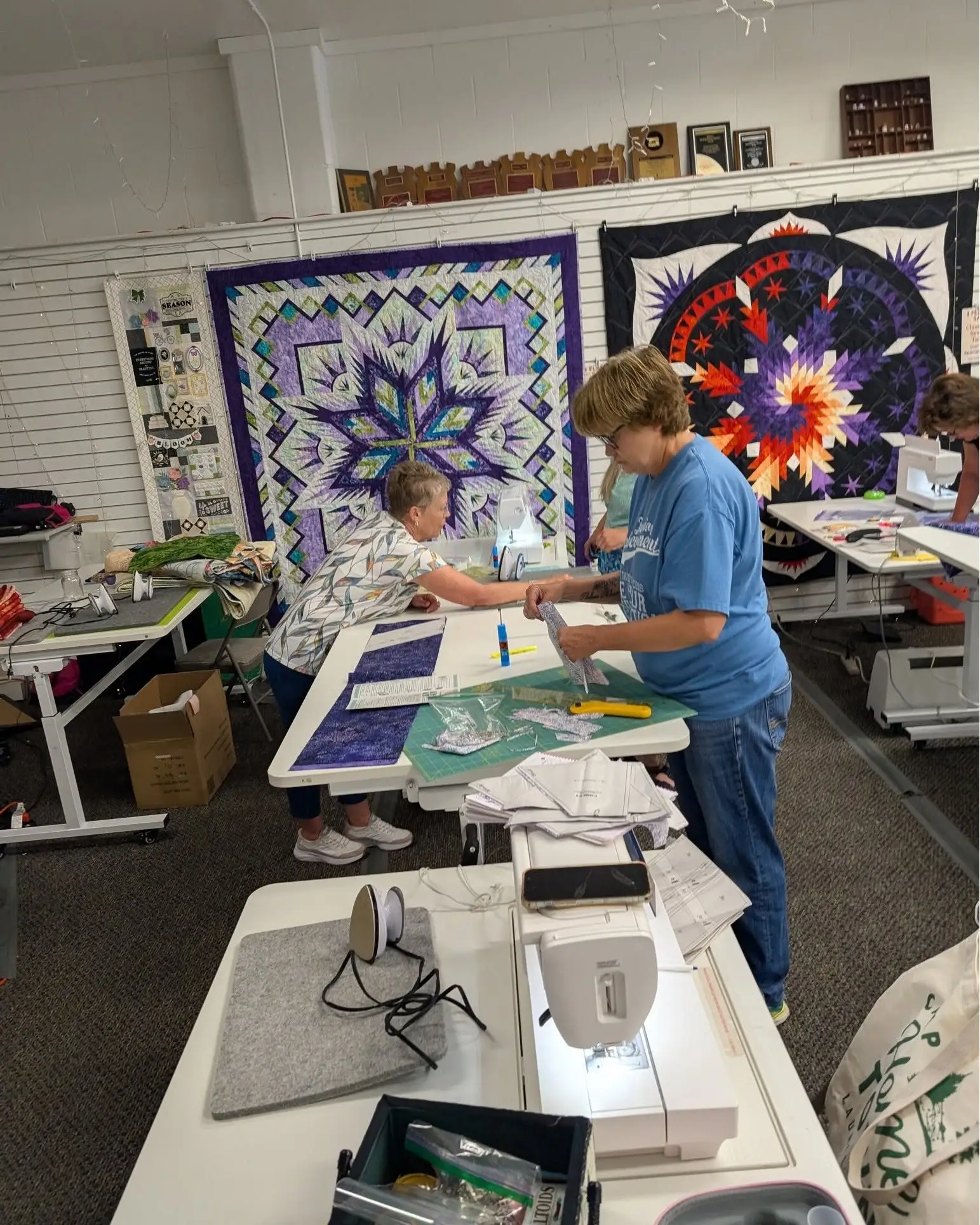 Quilters pressing and piecing their blocks in a foundation paper piecing workshop
