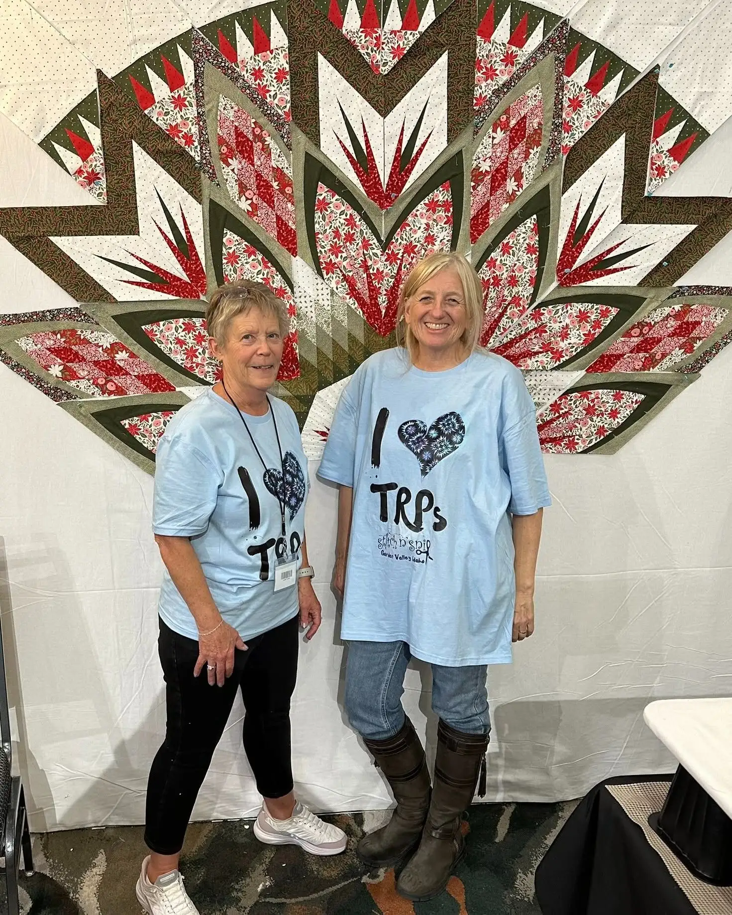 Karen Jarrett with Judy Niemeyer, founder of Quiltworx, in front of a finished Judy Niemeyer quilt