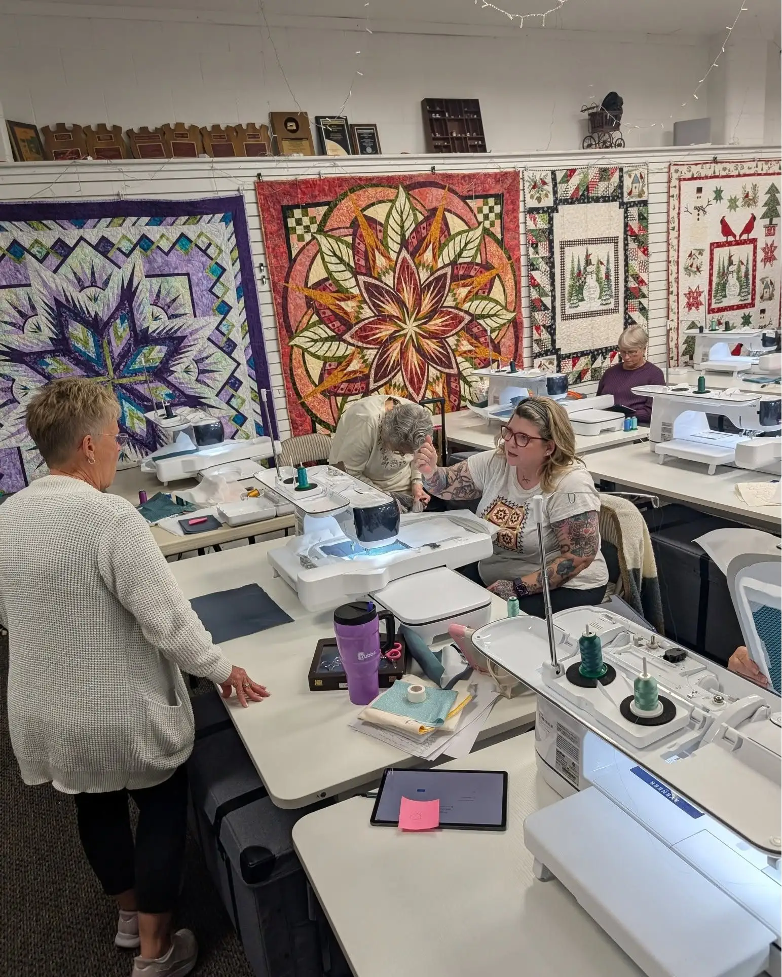 A Quiltworx foundation paper piecing class in session at rows of sewing machines